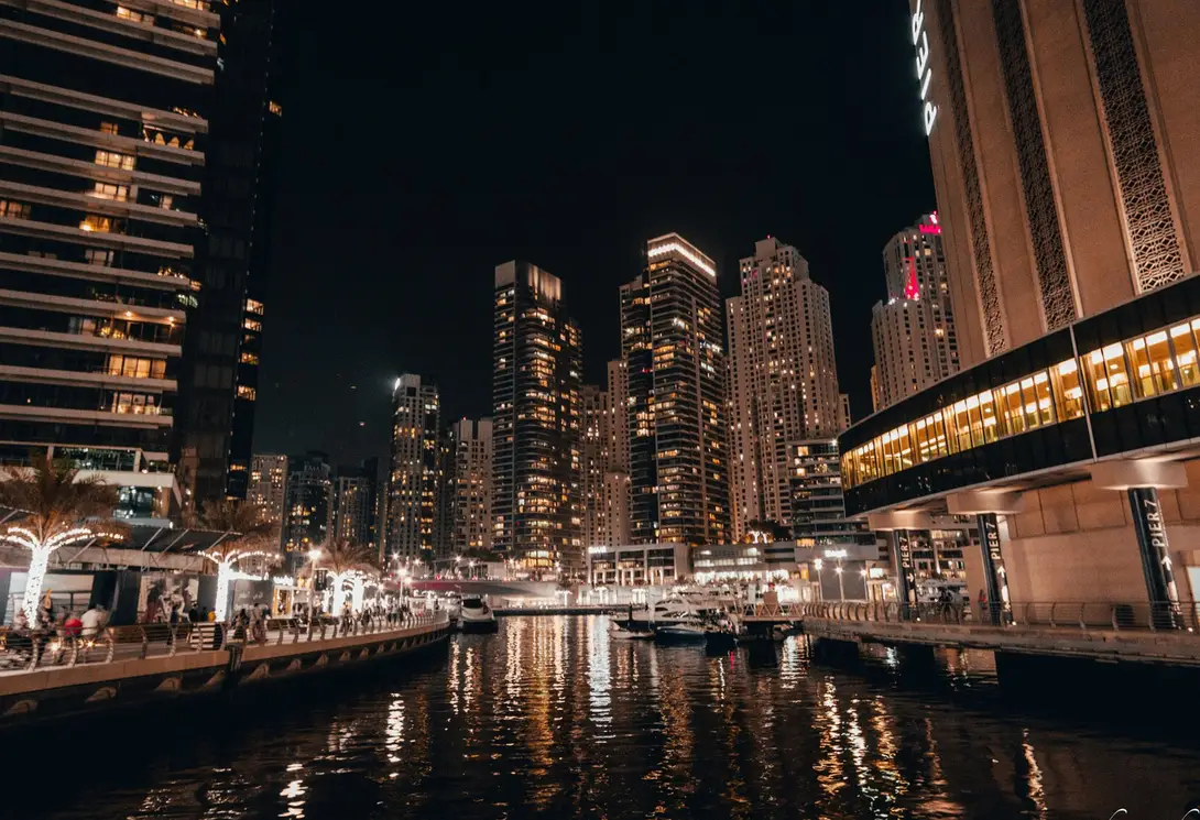 Dubai Marina at night, towers lit above the water
